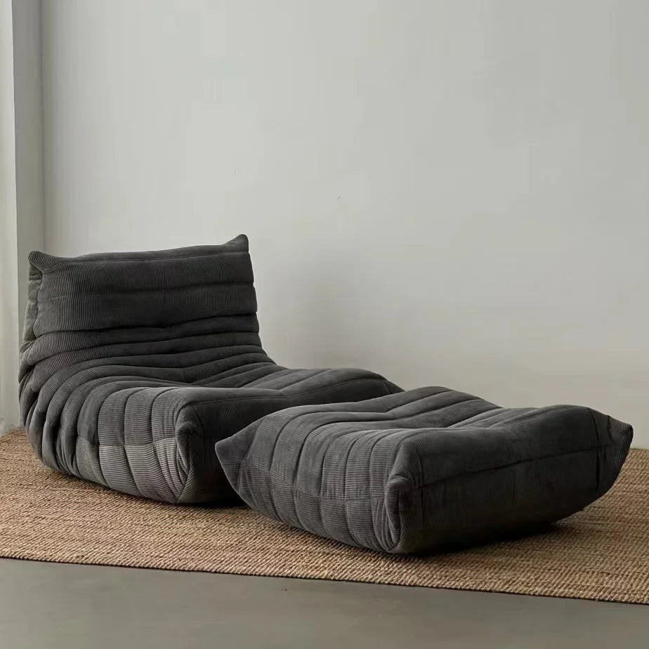 Chauffeuse basse en velours côtelé anthracite avec repose-pieds